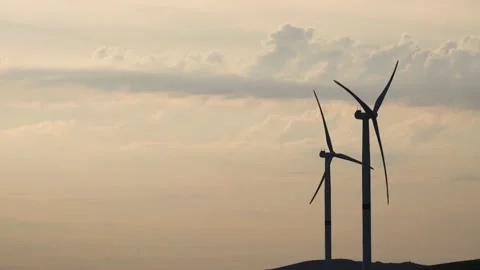 Motion the blades of a large wind turbine in a field against a background of Stock Footage 155295282