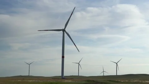 Motion the blades of a large wind turbine in a field against a background of Stock Footage 155295375