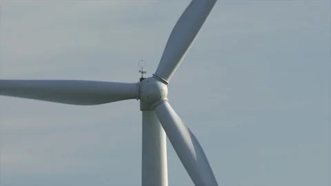 Motion the blades of a large wind turbine in a field against a background of Stock Footage 155295609