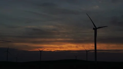 Motion the blades of a large wind turbine in a field against a background of Stock Footage 155436244