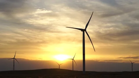 Motion the blades of a large wind turbine in a field against a background of Stock Footage 155436499