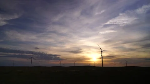 Motion the blades of a large wind turbine in a field against a background of Stock Footage 155437189