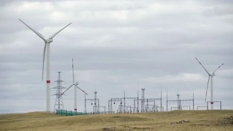 Motion the blades of a large wind turbine in a field against a background of Stock Footage 160318555