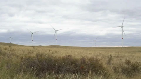 Motion the blades of a large wind turbine in a field against a background of Stock Footage 160318683