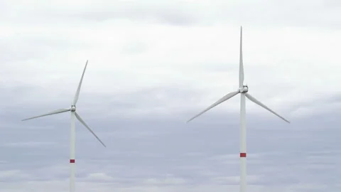 Motion the blades of a large wind turbine in a field against a background of Stock Footage 160318772