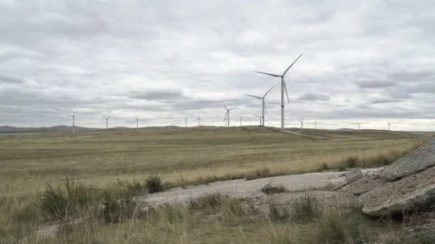 Motion the blades of a large wind turbine in a field against a background of Stock Footage 160319002