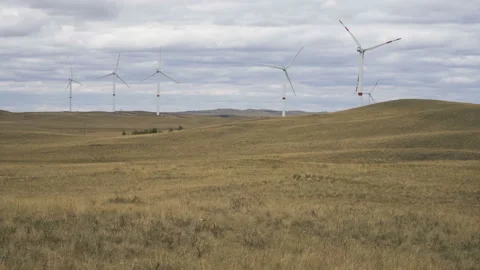 Motion the blades of a large wind turbine in a field against a background of Stock Footage 160320144