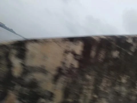 Motion blur of an aged concrete wall against an overcast sky Stock Photos