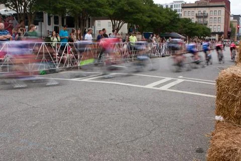 Motion Blur Of Cyclists Speeding Through Turn In Amateur Race Stock Photos