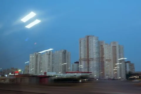 Motion blur of evening traffic passing modern residential towers Stock Photos