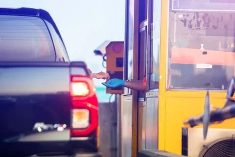Motion blur image of Driver pay for the expressway. Woman pays money to a cas Stockfoto's