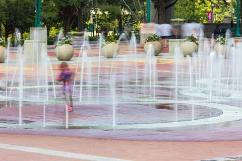 Motion blur of kid playing in Centennial Olympic Park fountain Stock Photos