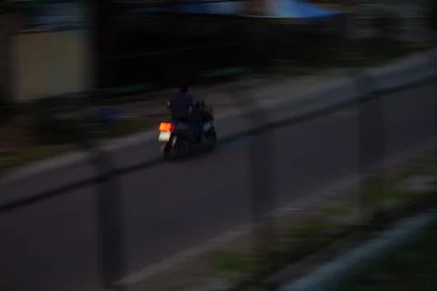 Motion Blur of Motorized Rickshaw Driving on Urban Road at Night Stock Photos