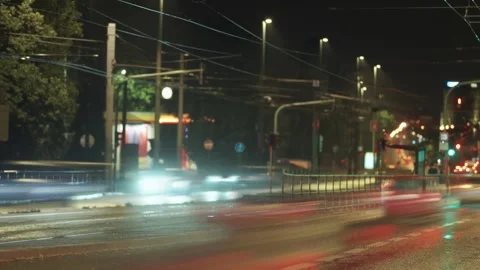 The motion blur of a passing tram and vehicles lights up the city street, Stock Footage 285625924