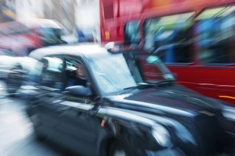 Motion blur picture of black cab and red double decker bus in the heart of lo Stock Photos