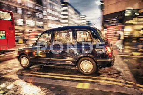 Motion Blur Picture Of Black Cab At Major Road Intersection In L