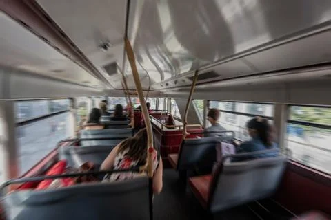 Motion blur radious of the atmosphere inside a red bus with passengers seat.. Stock Photos