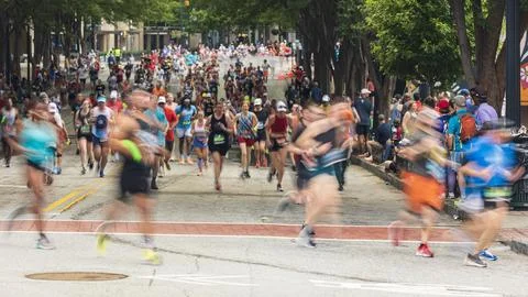 Motion blur shows thousands running in Atlanta Peachtree Road Race Foto stock