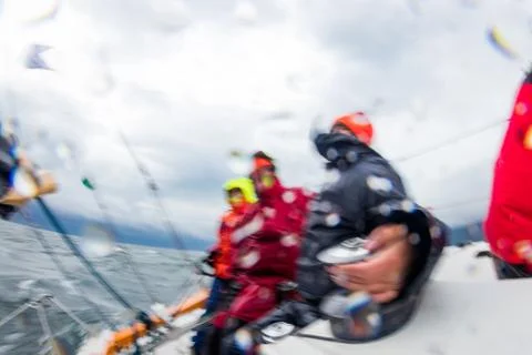 Motion blur with splashes people work with navigate of a yacht in the difficult Stock Photos