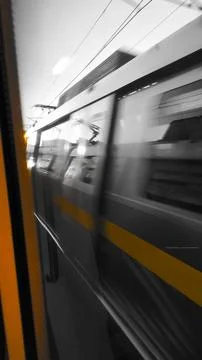Motion Blur of Train Passing Through Urban Setting Stock Photos