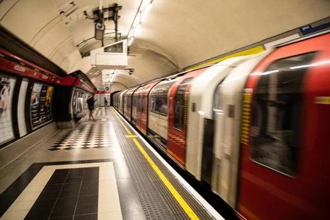 Motion-blurred Central Line train arriving at Holborn station on the London. Stock Photos