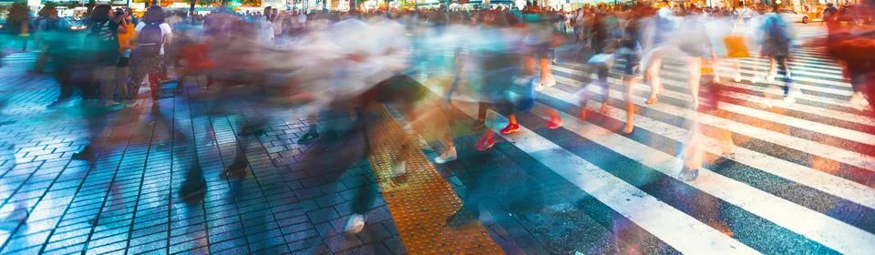 Motion blurred crowds converge at Shibuya Crossing, Tokyo, Japan Stock Photos