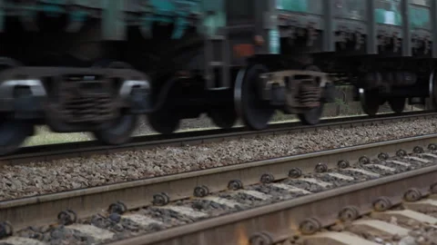 Motion blurred heavy cargo freight rusty train wagons moving on railway on Stock Footage 148687926