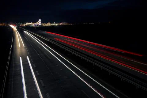 Motion blurred light tracks glowing to the darkness of highway traffic Foto stock