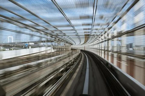 Motion-blurred view from a moving train running in tunnel Stock Photos