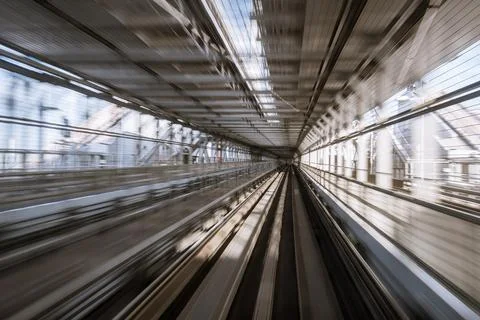 Motion-blurred view from a moving train running in tunnel Stock Photos