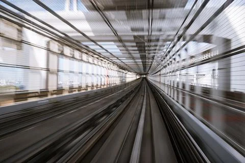 Motion-blurred view from a moving train running in tunnel Stock Photos