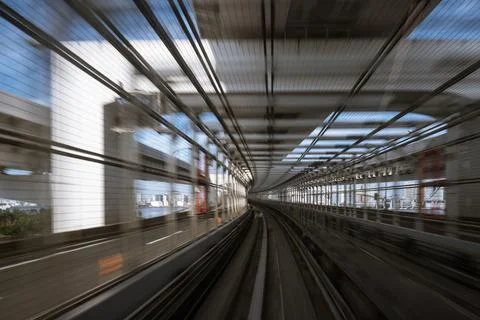 Motion-blurred view from a moving train running in tunnel Stock Photos