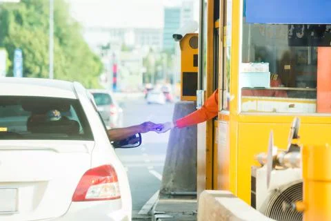 Motion blurry image of driver pay for the expressway. Man pays money to a cas Stock-Fotos