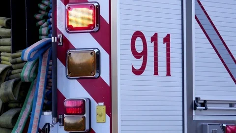 Motion of Burnaby fire emergency fire truck with 911 sign stopping at station Stock Footage