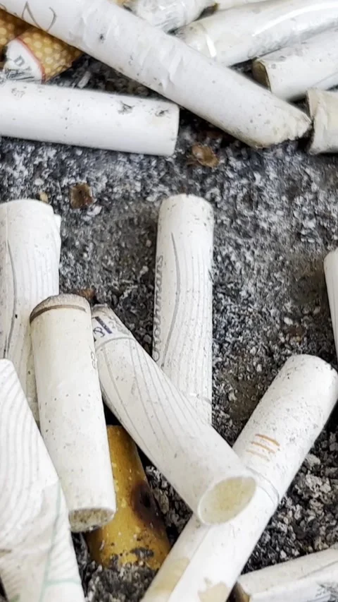 Motion camera background with smoked cigarette in ashtray. Vertical video Stock Footage 250384081