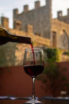Motion capture of red wine served with alcudia wall in the background from th Stock Photos