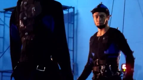 A motion capture stuntman flips on a hanging harness during production Stock Footage 58118244
