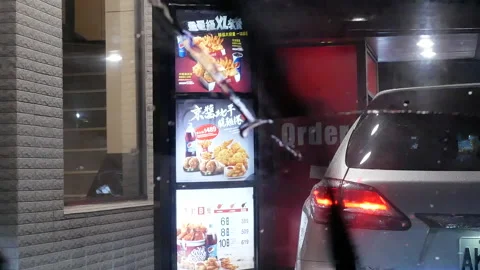Motion of car at drive through for ordering food while heavy raining night Stock Footage 94836673