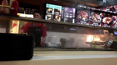 Motion of chef cooking food for customer with heavy smoke at food court Stock Footage 79914411