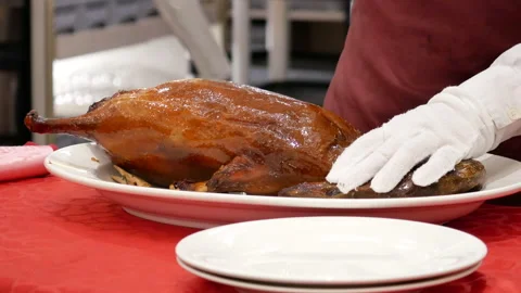 Motion of chef cutting roasted duck into a plate for customer 스톡 동영상 107070865