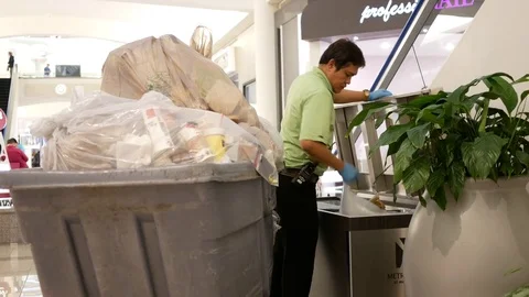Motion of cleaner changing garbage bag inside Buranby shopping mall with 4k r Stock Footage 83183375
