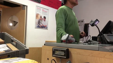 The motion of the clerk scanning the parcel for the customer at post office Stock Footage 236371968