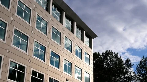 Motion of cloudy sky with illuminated reflected glass facade Video stock 79234818