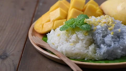 Motion of coconut milk on Coconut Flavored Sticky Rice with Ripe Mango Stock Footage 304893234