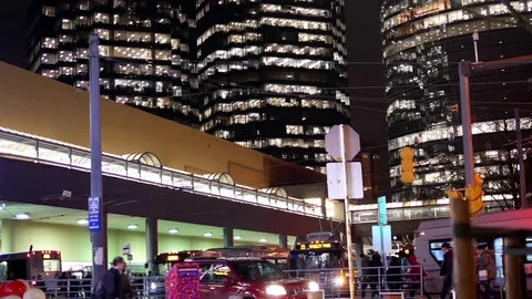Motion of commuters taking bus with big office buildings at night Stock Footage 70302089