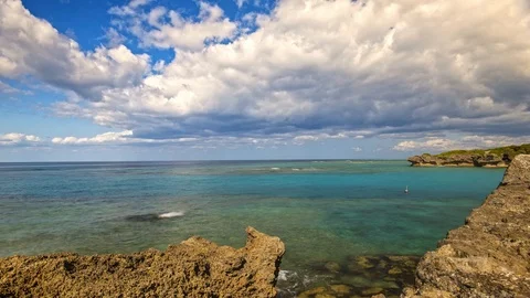 Motion controlled time-lapse of tropical ocean with blue sky reef and rocks. Stock Footage 123990315