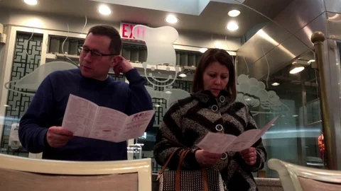 Motion of couple looking at menu and discussing price 動画素材 71001380