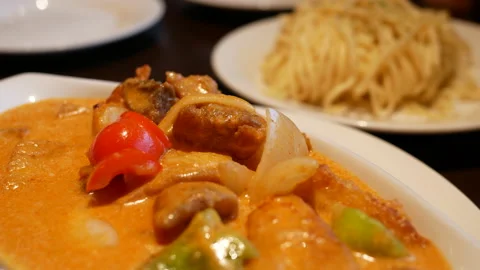 The motion of curry chicken and fried noodles on a table Stock Footage 203441499