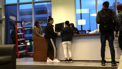 Motion of customer asking question about opening bank account inside TD Bank Stock Footage 94398160