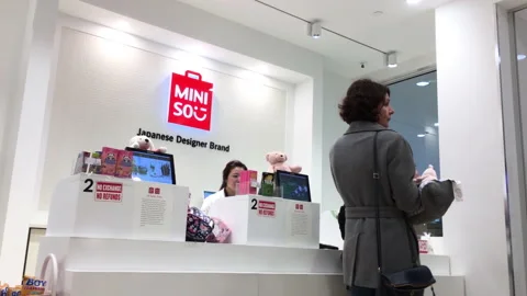 The motion of customer line up for paying goods at Miniso store Stock Footage 156077606